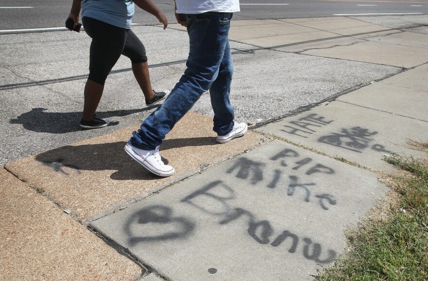 Graffiti remains on the sidewalk along West Florrisant Avenue one year after the shooting of Michael Brown on Aug. 12, 2015, in Ferguson, Missouri. Brown was shot and killed by a Ferguson police officer on August 9, 2014. (Scott Olson/Getty Images)