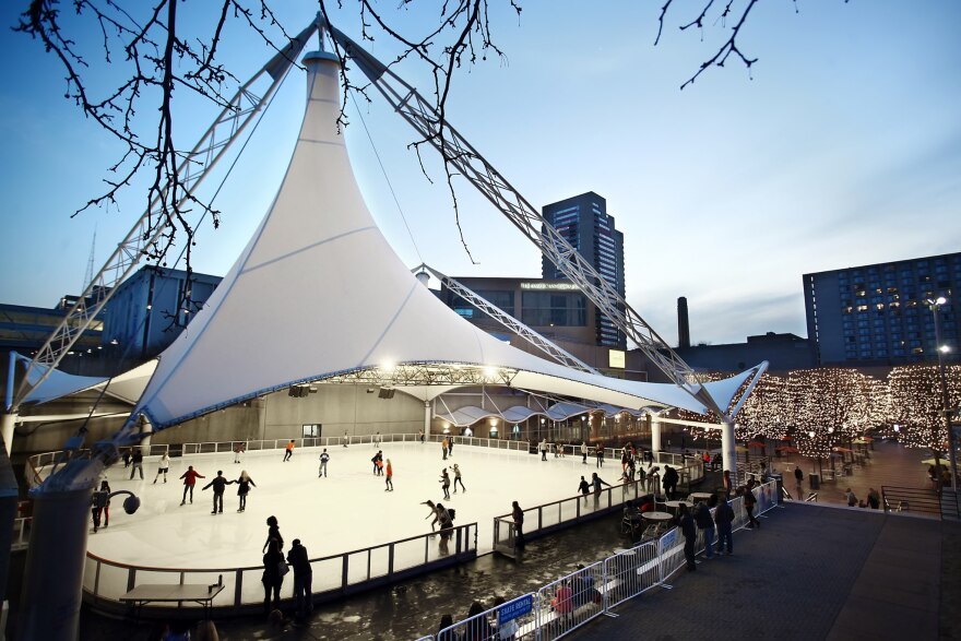 Dozens of skaters bundled up in hats and gloves glide across the ice rink at Crown Center Ice Terrace.