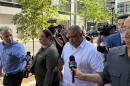 After being arraigned on 11 federal charges, Rep. Francisco Paulino of Methuen walks away from the Moakley Courthouse in Boston on Aug. 26, 2026, as members of the press ask him questions.