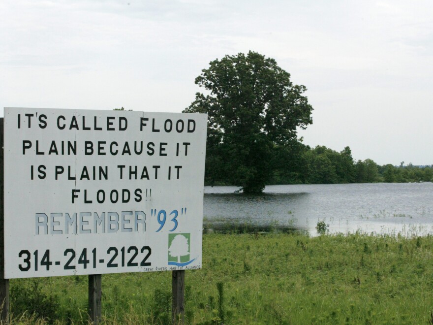 A sign in a field near Winfield, Mo., during a Mississippi River flood in 2008. The area suffered a similarly serious flood in 1993. The frequency of severity of flooding up and down the river have increased due to climate change and river control structures such as levees.