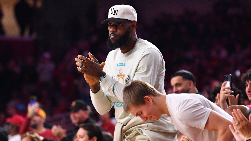 Lebron James celebrates after his son Bronny James' first basket for USC on Sonday.