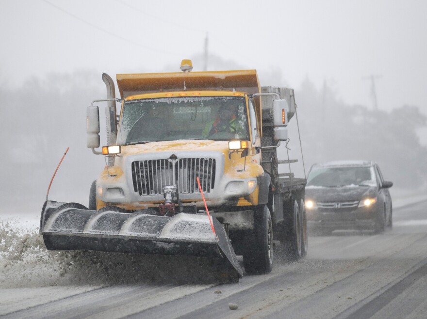 A plow clears snow from Road 438 in Douglas County near Lawrence, Kan., on Sunday. The area is under a blizzard warning. [Orlin Wagner / AP]
