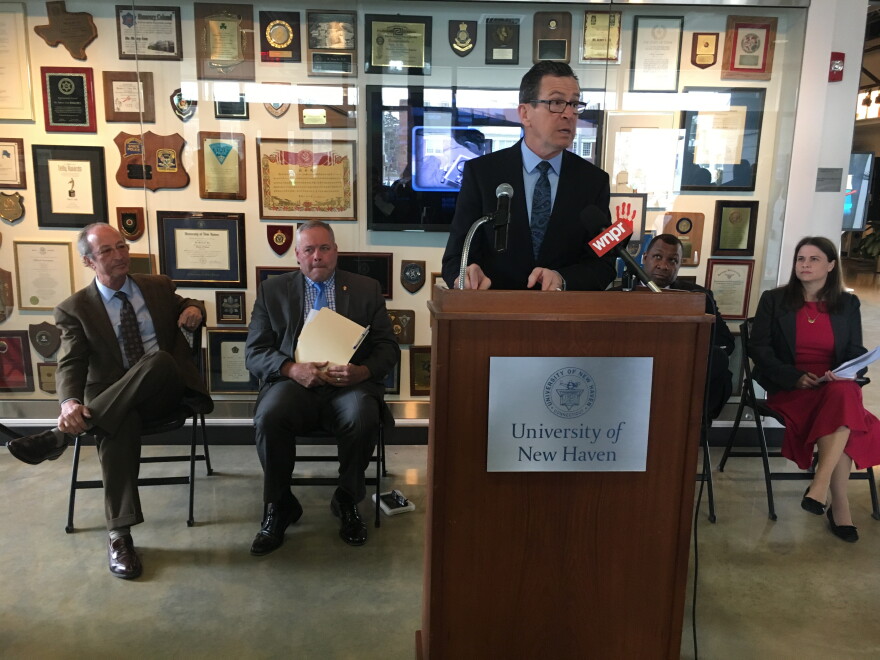 Gov. Malloy outlines juvenile justice proposals. Behind him, left to right, University of New Haven President Steven Kaplan, Commissioner Scott Semple, Sheriff Steven Tompkins, and Connecticut Juvenile Justice Alliance Executive Director Abby Anderson.