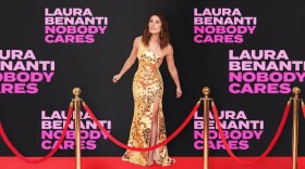 Artwork for "Laura Benanti: Nobody Cares" - a brunette woman in a gown is on a red carpet in front of a step and repeat 