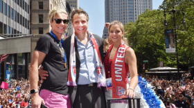 Abby Wambach with Governor Cuomo and his daughter aboard a float at today's parade