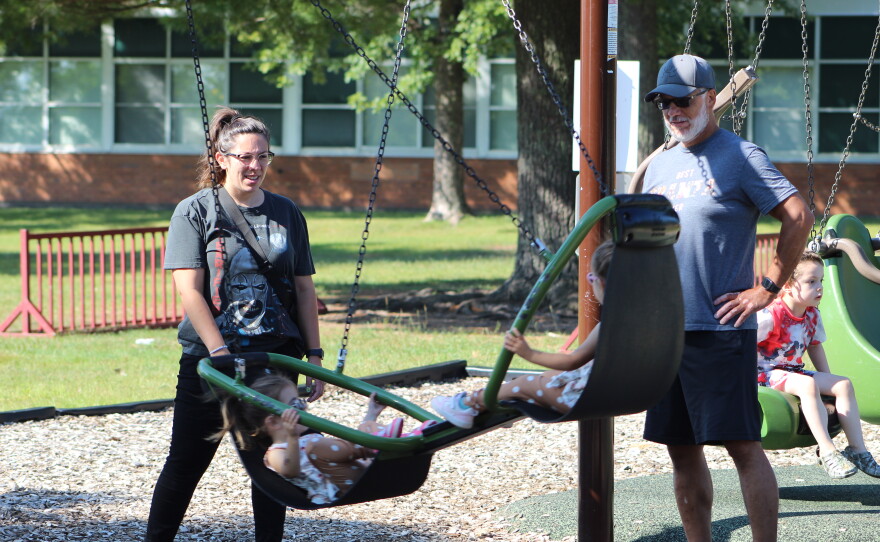 Sabrina Weberg and her dad, Dave Benz, play with her 2-year-old daughters Maya and Lucy on Aug. 27, 2026, at the Greenhaven playground in Hibbing.