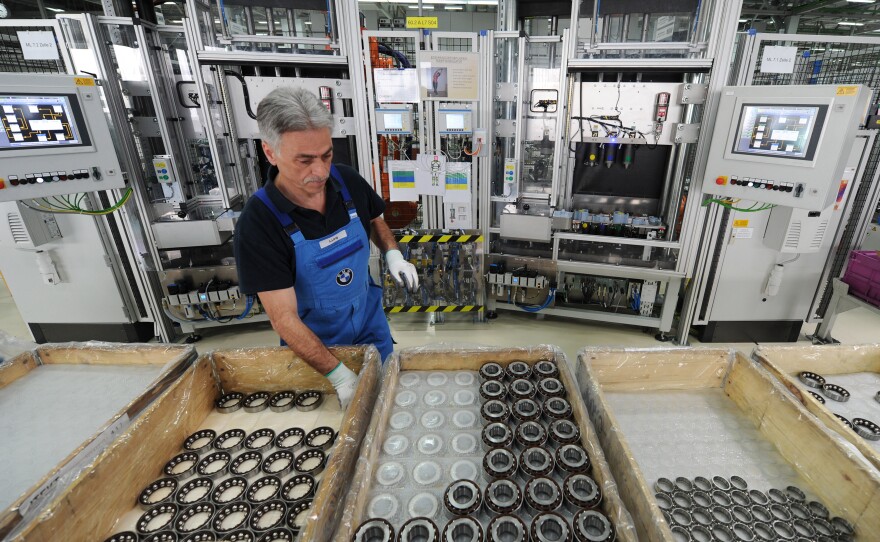 An employee works at the axle gear production line at a BMW plant in Dingolfing, southern Germany, on March 23, 2012. This BMW plant installed special ergonomic workspaces to help its rapidly aging workforce — a trend that's reflected in Germany's economy as a whole. That's one reason why critics oppose a new move to lower the country's early retirement age.