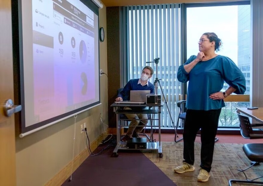 In this file photo, Jacen Greene, left, and Dr. Marisa Zapata look over data during the Point in Time Count of homelessness, in Portland, Jan. 25, 2023.
