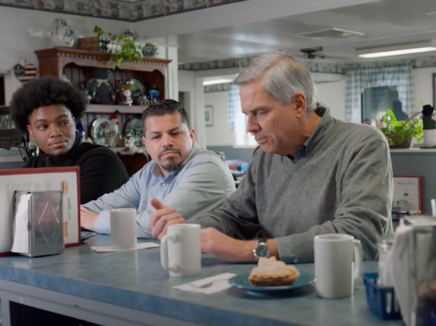 Scene from an ad: Bob Stefanowski talks to voters in a diner in one of his first TV ads, stressing a middle-class background .