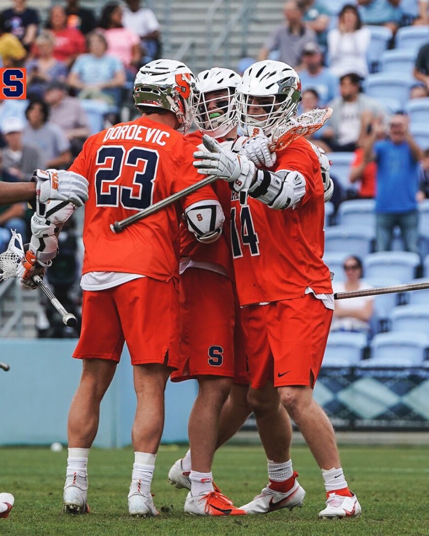 SU attackers huddle after taking the lead in the fourth quarter.