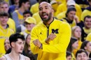 Justin Joyner gestures on the sidelines of a basketball game