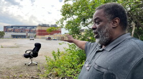 Leon Bates points to a parking lot where the Greenlawn Cemetery used to be.