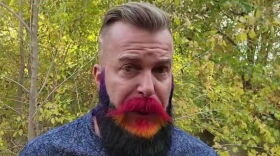 A man with a rainbow colored beard