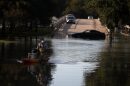 A resident pulls personal belongings on a kayak as he wades through floodwaters on Sept. 6, 2017 in Houston, Texas. (Justin Sullivan/Getty Images)