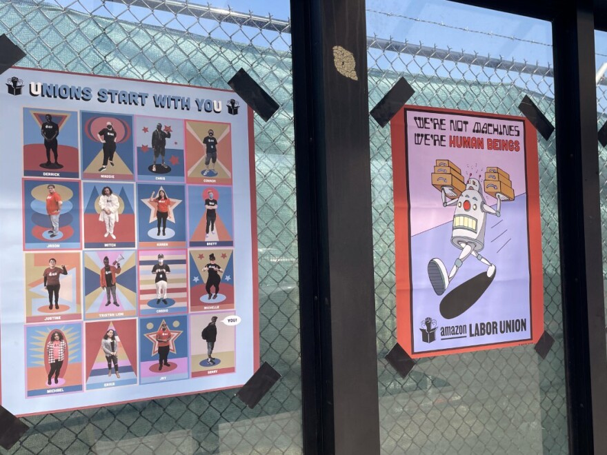 Signs are posted outside the the Amazon fulfillment center in Staten Island borough of New York at a bus stop on March 16.