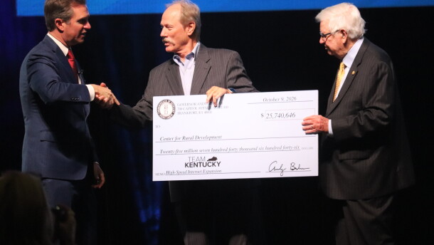 Gov. Andy Beshear (left) and U.S. Rep. Hal Rogers (right), present a check to Lonnie Lawson, director of the Center for Rural Development.
