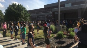 People standing earing face masks.