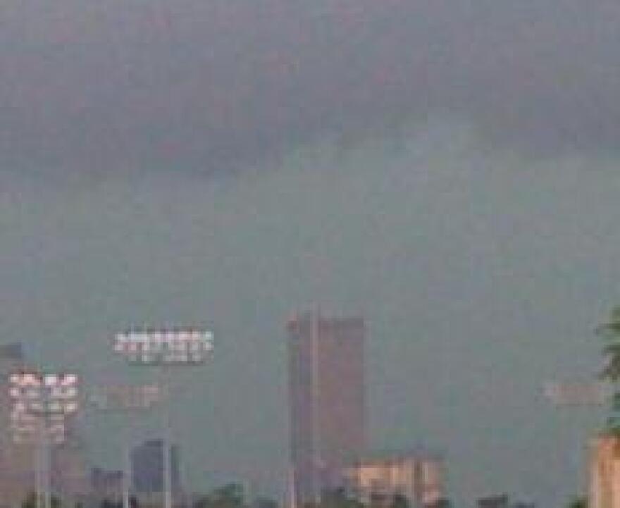 A heavy thunderstorm moves over the Tulsa skyline.