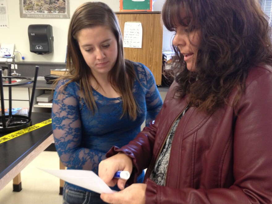 Jessica goes over her work with teacher Jennifer Goodnight. Goodnight says "flipping" her class has improved students' test scores.