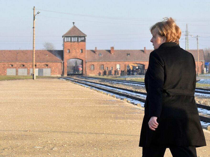 German Chancellor Angela Merkel walks toward the main railway entrance to Birkenau, the largest of the camps that made up the Auschwitz complex in Poland. It was the German chancellor's first visit to the former Nazi death camp, an enduring symbol of the Holocaust, since taking office 14 years ago.