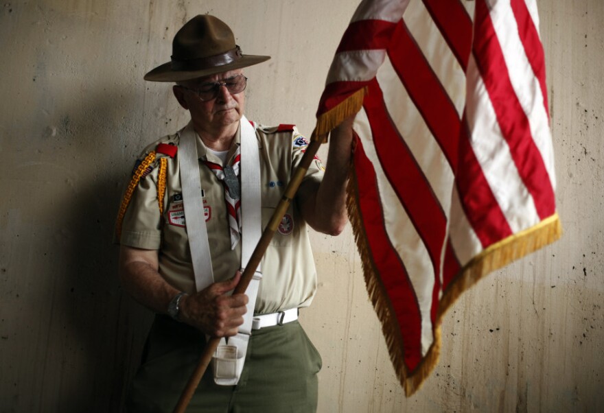 Richard Marsden with Boy Scout Troop 226 prepares an American flag before a Memorial Day parade in Philadelphia on Monday.
