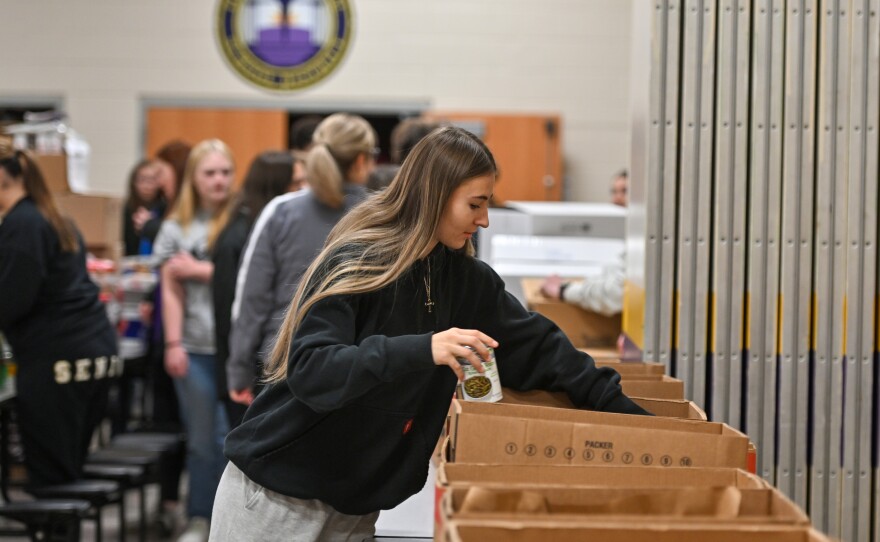 Forest City junior Kayla Pecko packs boxes with green beans.