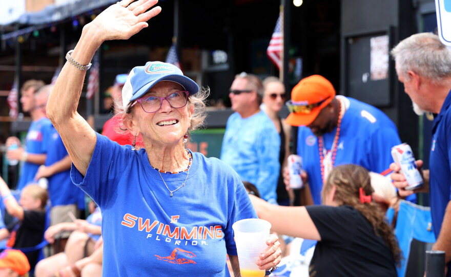 Susan Eisen waves at paraders during the University of Florida Homecoming parade in Gainesville Friday, Oct. 9, 2026. (Isabel Kraby/WUFT News)
