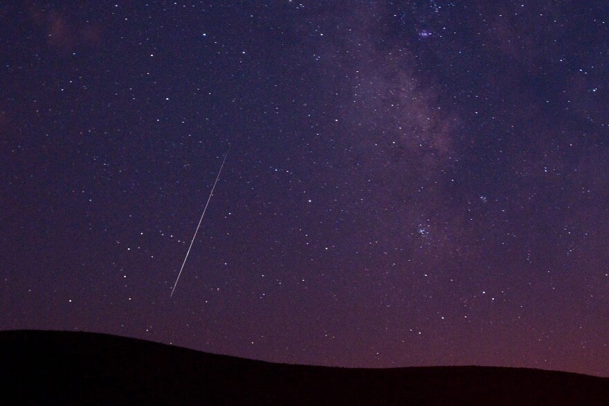 A meteor streaks across the sky during the Perseid meteor shower 