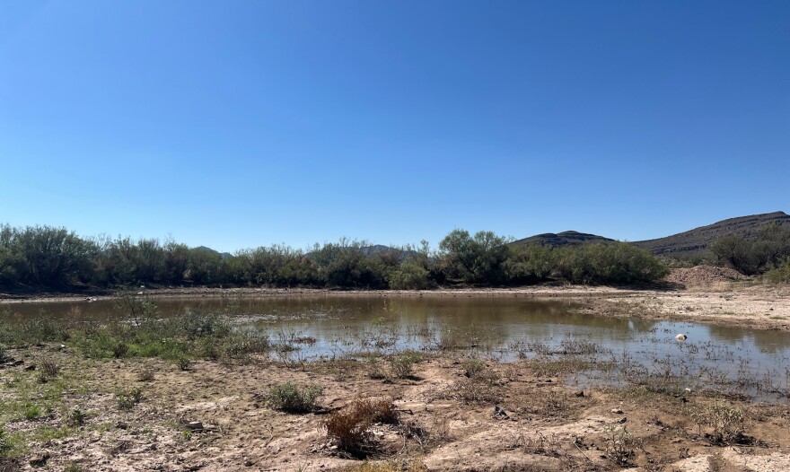 Sunlight reflects off the water at the reservoir known as Fivemile Tank near Sierra Blanca, Texas.