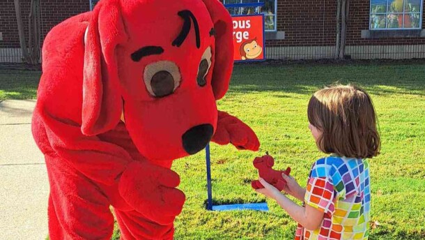 Joy Holmes’ 5-year-old daughter meets Clifford the Big Red Dog at Arkansas PBS Family Day in Conway on Sept. 27, 2025.