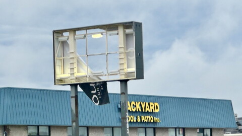 Storm damage at a business, on its sign, exterior to the building