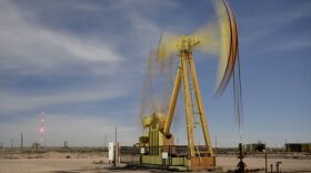 A pumpjack operates north of Carlsbad, where the New Mexico Environment Department air quality monitoring station recorded ozone levels that could lead the EPA to declare the region an ozone non-attainment zone. The air pollution comes from oil and gas operations in the area.