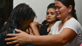 A survivor cries as she arrives at hospital in Cebu after a ferry collided with a cargo ship in Cebu, central Philippines on Friday.
