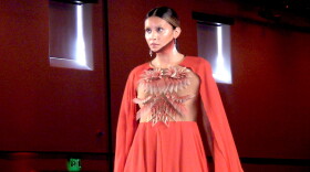 Leamya Brown models a dress designed by Southern Ute and Navajo designer Adrian Standing Elk Pinnecoose at SWAIA's 102nd annual Santa Fe Indian Market.