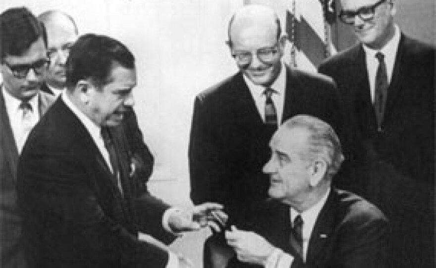 President Lyndon B. Johnson hands U.S. Rep. Dante Fascell the pen used to sign the act creating the Biscayne National Monument in 1968 that later became the national park. Behind him are Joe Browder, Lloyd Miller and Hardy Matheson.