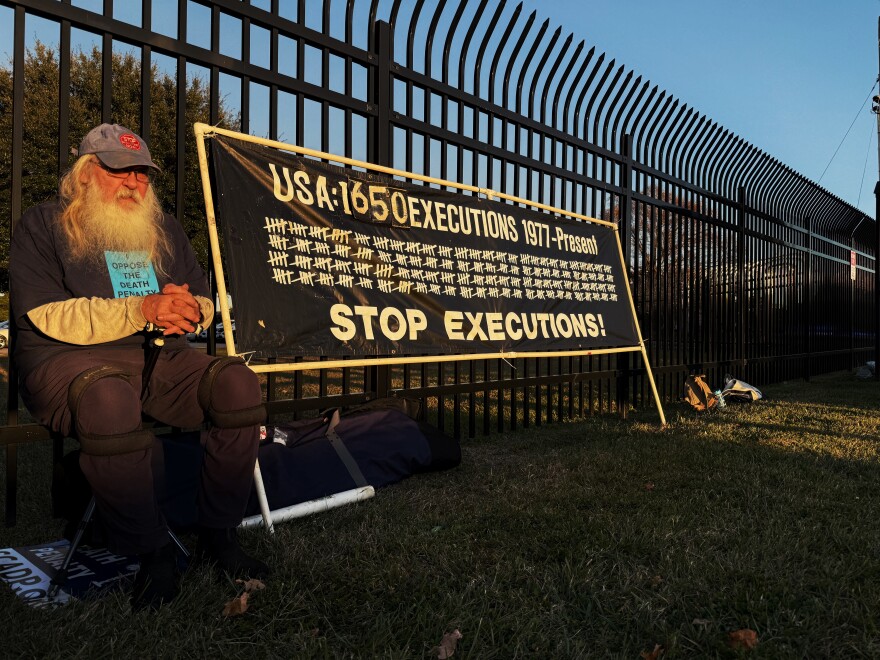 Rob Kaz sits outside the South Carolina Department of Corrections complex in Columbia to protest 44-year-old Stephen Bryant's execution." Kaz was one of about 20 protestors.
