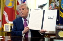 President Donald Trump holds up a signed executive order in the Oval Office of the White House, Thursday, Aug. 27, 2026, in Washington.