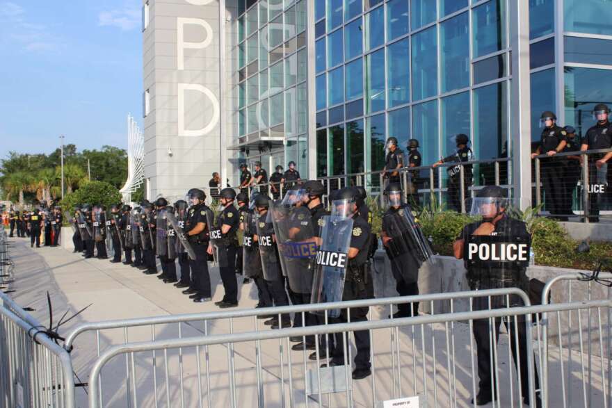 Orlando Police officers in riot gear stand guard outside the OPD headquarters, May 31st, 2020. Photo: Matthew Peddie, WMFE