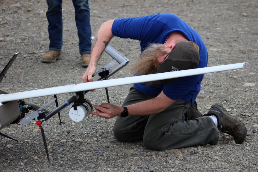 Jason Williams removes containers filled with water from a drone at Furie Operating Alaska’s central processing facility.