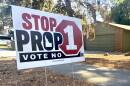 A close up of a yard sign against Proposition one. 