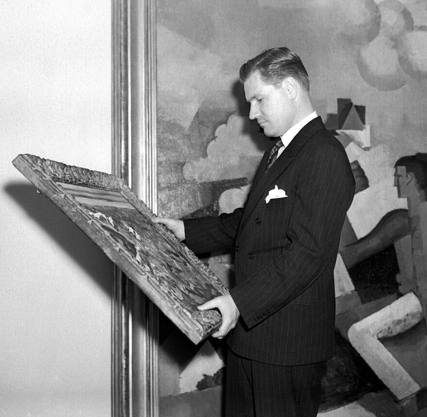 Nelson Rockefeller examines a painting at New York's Museum of Modern Art in 1939. Rockefeller was 23 when he hired Diego Rivera to paint a mural in the newly built Rockefeller Center.