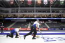 Team Persinger's Ben Richardson, left, watches as Alex Leicther, front, and Greg Persinger sweep to curl the rock down the sheet while competing against Team Shuster at the U.S. Olympic Curling Team Trials at Baxter Arena in Omaha, Neb., Wednesday, Nov. 17, 2021.
