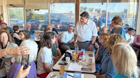 Gov. JB Pritzker speaks to Emily Waugh of Oregon at Lulu’s Diner in Springfield on Thursday, Aug. 27, 2026.