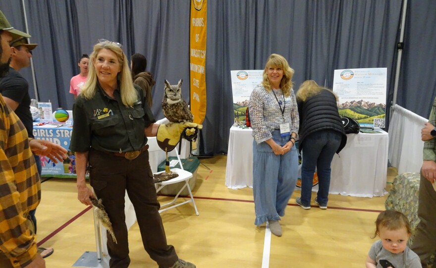 Ranger and naturalist at the Wasatch Mountain State Park, Kathy Donnell, holds an owl and speaks with an attendee at the "Ask Heber Valley Community Expo" on April 11.