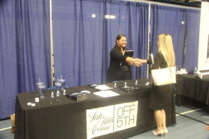 Amanda Shuey (left), campus recruiter for Saks Fifth Avenue, interviews with Haley Doyle, a 21-year-old UF marketing senior, at the University of Florida's fall Career Showcase. Photo by Griffin Horvath.