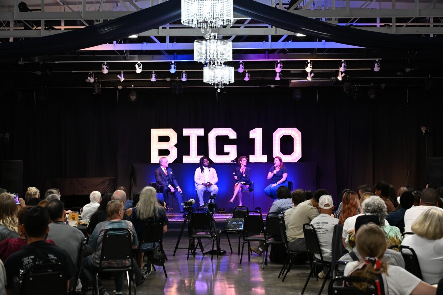 Panelists speak on the stage about the cost of AI data centers as Tulsa residents listen in during the Tulsa forum organized by the Foundation for Real Economic Emancipation.