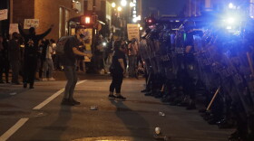 Protesters shout at Kentucky State Police officers as they protest the death of George Floyd and Breonna Taylor, Friday, May 29, 2020, in Louisville, Ky.