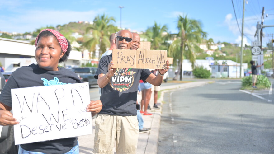 Pictured: Members of the Virgin Islands Progressive Movement hold signs calling for improvements to WAPA's electricity service during a protest outside the utility's newly leased Four Winds office on St. Thomas.