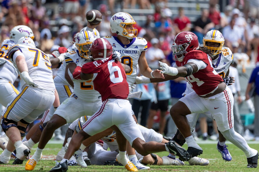 East Carolina quarterback Emory Williams (9) throws a pass as Alabama defensive lineman Edric Hill (94) pressures the play during the second half of an NCAA college football game Saturday, Sept. 5, 2026, in Tuscaloosa, Ala. (AP Photo/Vasha Hunt)