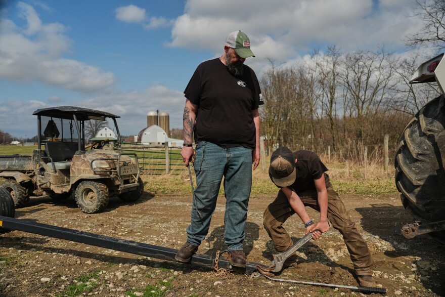 Blake Greier, 13, works to repair a hitch as his father, Wayne, left, helps Tuesday, March 10, 2026, in Canfield, Ohio.